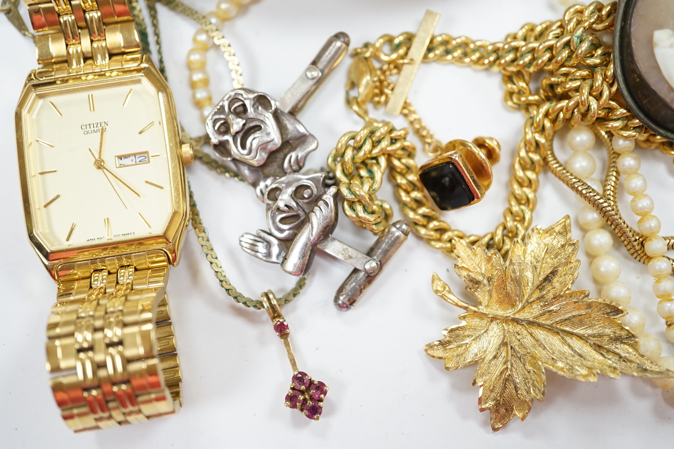 A small 9ct gold and gem set pendant, 22mm, three gilt metal chains, two white metal cufflinks, a Citizen watch, other costume jewellery and three ceramic items.